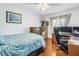 Comfortable bedroom offering a functional workspace, complemented by natural light and hardwood floors at 5037 Starfish Se Dr # A, St Petersburg, FL 33705