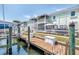 View of a boat dock with lush green landscaping and waterfront property at 5037 Starfish Se Dr # A, St Petersburg, FL 33705