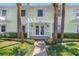Inviting building entrance with palm trees, a white pergola, and brick walkway at 5037 Starfish Se Dr # A, St Petersburg, FL 33705