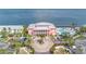 Aerial view of the clubhouse, circular driveway, and landscaping with the pool and ocean in the background at 5037 Starfish Se Dr # A, St Petersburg, FL 33705