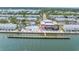 Aerial view of a community clubhouse, with a pier, pool, and scenic waterfront views at 5037 Starfish Se Dr # A, St Petersburg, FL 33705