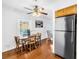 Cozy dining area with wood table, chairs, and a view of the living room and kitchen at 5037 Starfish Se Dr # A, St Petersburg, FL 33705