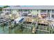 A waterfront exterior view of condos with boat docks and lifts on a sunny day at 5037 Starfish Se Dr # A, St Petersburg, FL 33705