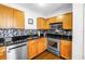 Updated kitchen with stainless steel appliances, black granite countertops, and ample cabinet space at 5037 Starfish Se Dr # A, St Petersburg, FL 33705