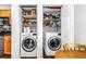 Efficient laundry area with modern washer and dryer units, nestled beside the kitchen, maximizing space at 5037 Starfish Se Dr # A, St Petersburg, FL 33705