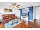 Stylish living room featuring dark wood floors, a ceiling fan, and comfortable seating at 5037 Starfish Se Dr # A, St Petersburg, FL 33705