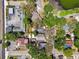 Aerial view of the property showcasing the surrounding neighborhood and mature trees at 5806 N 9Th St, Tampa, FL 33604