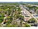 Aerial view of a neighborhood featuring mature trees, roadways, and distant city skyline at 5806 N 9Th St, Tampa, FL 33604