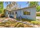 The rear of the home shows a step-down entrance and brick path at 5806 N 9Th St, Tampa, FL 33604