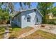 Exterior view of a charming home featuring a brick pathway and cozy outdoor fire pit at 5806 N 9Th St, Tampa, FL 33604