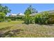Spacious backyard featuring green foliage and glimpses of neighboring houses at 5806 N 9Th St, Tampa, FL 33604