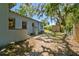 Backyard of home showing landscaped areas and a utility building at 5806 N 9Th St, Tampa, FL 33604