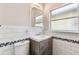 Well-lit bathroom with a toilet, modern vanity, and a window for natural light at 5806 N 9Th St, Tampa, FL 33604