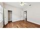 Bedroom with hardwood floors featuring two doors, one closet, and one leading to another room at 5806 N 9Th St, Tampa, FL 33604