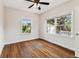 Bedroom featuring hardwood floors, modern ceiling fan, and an abundance of natural light at 5806 N 9Th St, Tampa, FL 33604