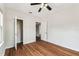 Bedroom featuring hardwood floors, modern ceiling fan, and a closet at 5806 N 9Th St, Tampa, FL 33604
