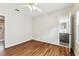 Bedroom with hardwood floors featuring one door to a bathroom and one to another room at 5806 N 9Th St, Tampa, FL 33604