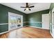 Bedroom with hardwood floors, green walls, french doors, and white trim at 5806 N 9Th St, Tampa, FL 33604