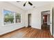 Bright bedroom featuring hardwood floors, white walls, and closet at 5806 N 9Th St, Tampa, FL 33604