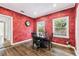 Cozy dining room with dark wood floors, red walls and a table setting at 5806 N 9Th St, Tampa, FL 33604