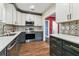 Well-equipped kitchen featuring stainless steel appliances, modern countertops, and ample storage in stylish cabinets at 5806 N 9Th St, Tampa, FL 33604