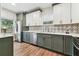 Modern kitchen featuring stainless steel appliances, stylish backsplash, and custom cabinets at 5806 N 9Th St, Tampa, FL 33604