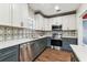 Bright kitchen with stainless steel appliances, decorative backsplash, sleek countertops, and ample cabinet space at 5806 N 9Th St, Tampa, FL 33604