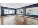 Inviting living room with gleaming hardwood floors, blue walls, and natural light at 5806 N 9Th St, Tampa, FL 33604