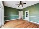 This living room features hardwood floors, modern ceiling fan, and custom doors at 5806 N 9Th St, Tampa, FL 33604