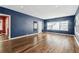 Spacious living room with hardwood floors, natural light, and freshly painted blue walls at 5806 N 9Th St, Tampa, FL 33604