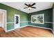 This living room features hardwood floors, modern ceiling fan, and custom doors at 5806 N 9Th St, Tampa, FL 33604