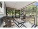 Relaxing screened porch featuring comfortable seating, perfect for enjoying the outdoors at 5806 N 9Th St, Tampa, FL 33604