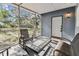 Cozy screened-in porch with seating area, creating a comfortable outdoor living space at 5806 N 9Th St, Tampa, FL 33604