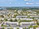 Wide aerial view of Shoreview East community, lake, surrounding vegetation and the location of the unit at 5980 Terrace Park N Dr # 214, St Petersburg, FL 33709
