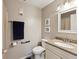 Well-lit bathroom features a granite-topped vanity, framed mirror, towel rack, and neutral wall color at 5980 Terrace Park N Dr # 214, St Petersburg, FL 33709