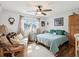 Cozy bedroom featuring a comfortable bed, daybed, ceiling fan, and natural light from the window at 5980 Terrace Park N Dr # 214, St Petersburg, FL 33709