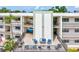 Exterior common area showcasing outdoor seating, a balcony, and neutral color scheme at 5980 Terrace Park N Dr # 214, St Petersburg, FL 33709