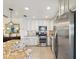Modern kitchen with stainless steel appliances, granite countertops, and ample cabinet space for culinary enthusiasts at 5980 Terrace Park N Dr # 214, St Petersburg, FL 33709