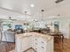 Open-concept living area showcases a stylish granite kitchen island and flows into dining and relaxing living spaces at 5980 Terrace Park N Dr # 214, St Petersburg, FL 33709