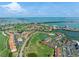 An aerial view shows the community by a lake, a pool, and a water view at 6171 Bahia Del Mar Blvd # 216, St Petersburg, FL 33715