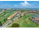 Aerial view showcases the community, manicured golf course, serene lake, and stunning waterfront views at 6171 Bahia Del Mar Blvd # 216, St Petersburg, FL 33715