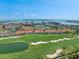 Wide aerial view featuring the complex, a golf course, lake, the city and the ocean at 6171 Bahia Del Mar Blvd # 216, St Petersburg, FL 33715