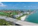 This aerial captures a waterfront community, featuring golf course, bridge, and sandy beach at 6171 Bahia Del Mar Blvd # 216, St Petersburg, FL 33715
