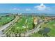 This aerial view highlights the golf course community, adjacent highway, and waterfront views at 6171 Bahia Del Mar Blvd # 216, St Petersburg, FL 33715