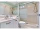 Clean bathroom with walk-in shower, a frosted glass partition, and a vanity at 6171 Bahia Del Mar Blvd # 216, St Petersburg, FL 33715
