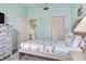 Comfortable bedroom with soft blue walls and a view into the ensuite bathroom at 6171 Bahia Del Mar Blvd # 216, St Petersburg, FL 33715