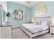 Calming bedroom with palm tree views from the window, a modern bed, and a dresser at 6171 Bahia Del Mar Blvd # 216, St Petersburg, FL 33715
