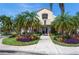 Inviting clubhouse entrance framed by lush landscaping and palm trees, offering a warm welcome at 6171 Bahia Del Mar Blvd # 216, St Petersburg, FL 33715