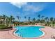 Community pool surrounded by ample lounge chairs and lush tropical landscaping offering a resort-like feel at 6171 Bahia Del Mar Blvd # 216, St Petersburg, FL 33715