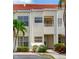 Inviting two-story condo featuring a red tile roof, lush landscaping, and convenient parking at 6171 Bahia Del Mar Blvd # 216, St Petersburg, FL 33715